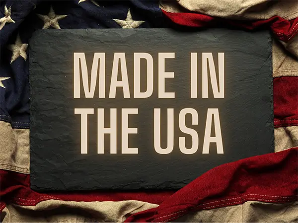 A dark-gray slate with the words Made in the USA printed on it, surrounded by an American flag.