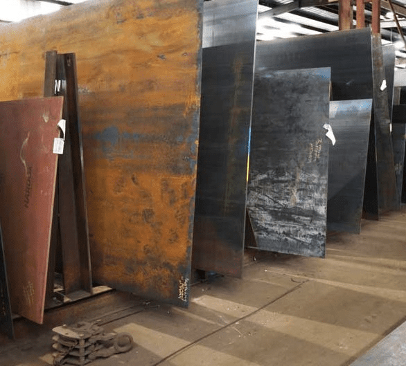 Corten steel panels lined up in a foundry.